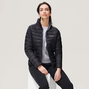 Jacket with logo Ride Woman Jacket with logo lightweight in lightly padded figure-sewn style. Contrast colour to the lining and zippers. Wind and water repellent materials. 2 zipped pockets with matching lining. High collar, banded with tone-on-tone at the hem and sleeves. Fabric details: Outer fabric 100% nylon, Lining 100% nylon, Padding: 100% polyester - 180g/m2. Depending on the surface we can use embroidery, engraving, 360° imprint or screen print.